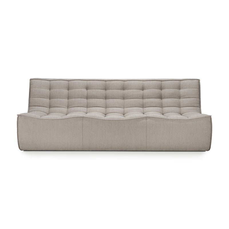 Three seat sofa shown in ecru colored fabric on white background with shadows