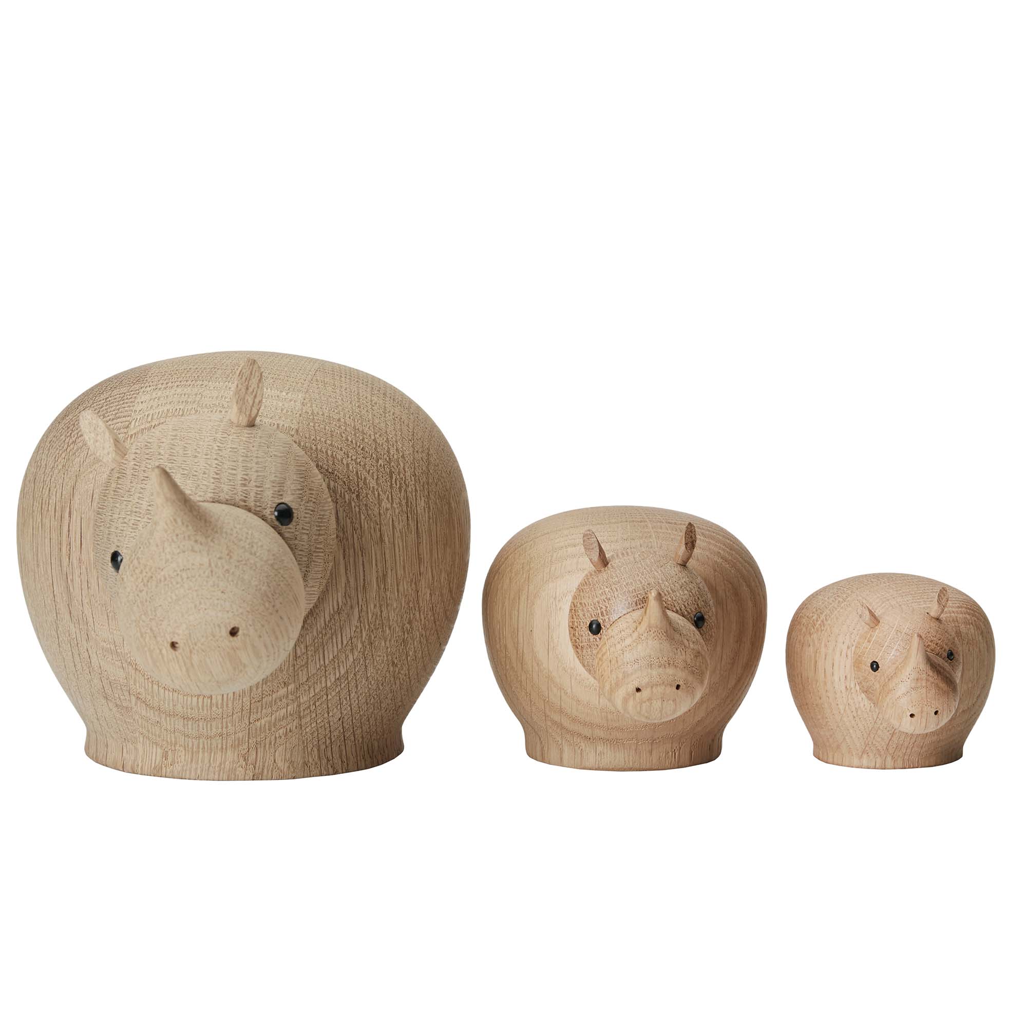 Three wooden rhino figurines of different sizes on a white background