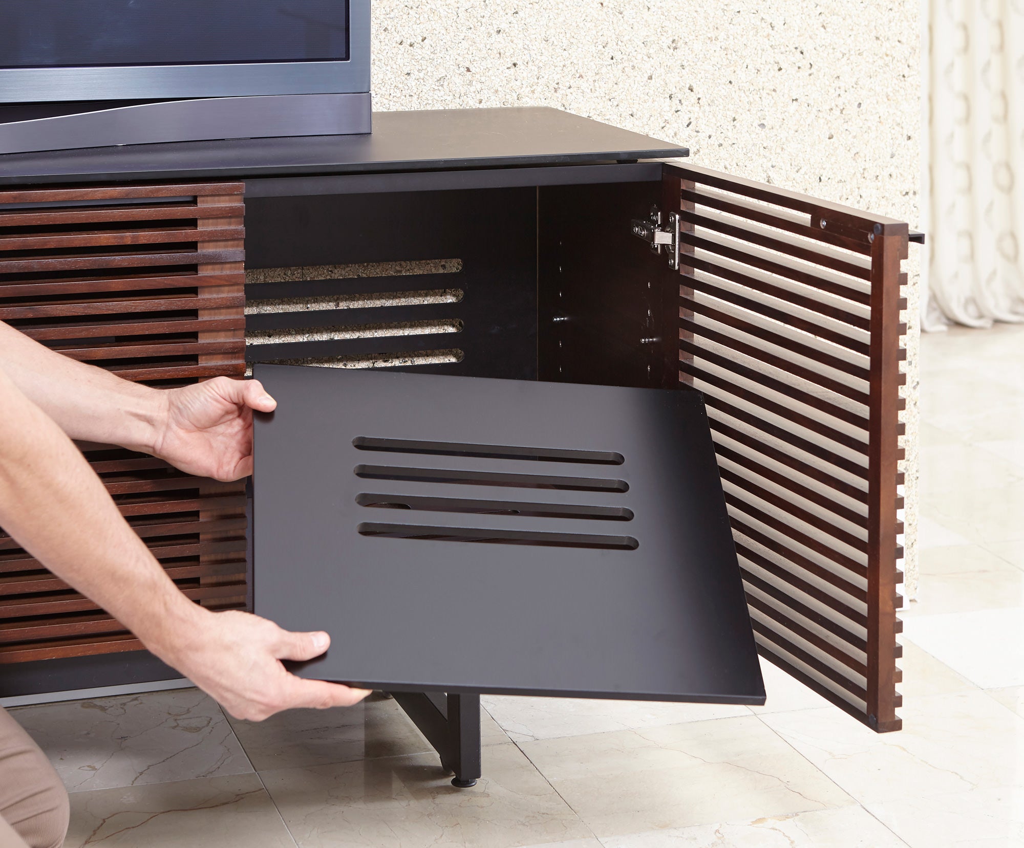 A person resetting an adjustable shelf