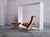 Red leather Siesta chair in urban environment with white brick background and concrete flooring GALLERY
